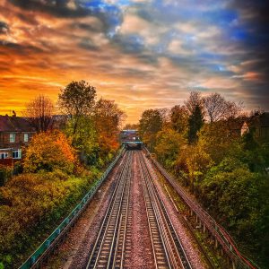 West London train tracks set in front of a stunning red sunrise