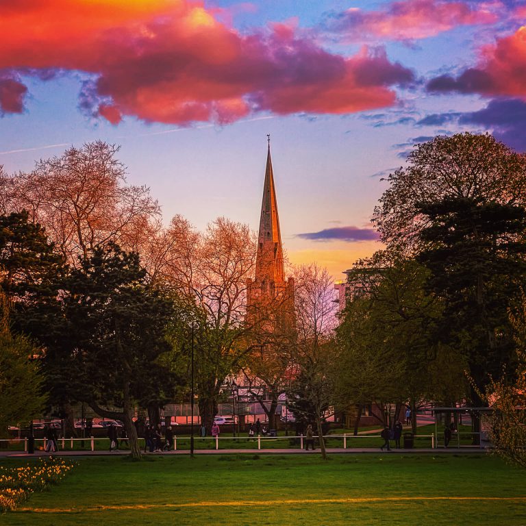 A park in West London looking onto a beautiful church