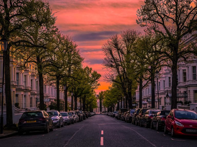 A perfectly symmetrical picture staring down a straight, West London road at dusk