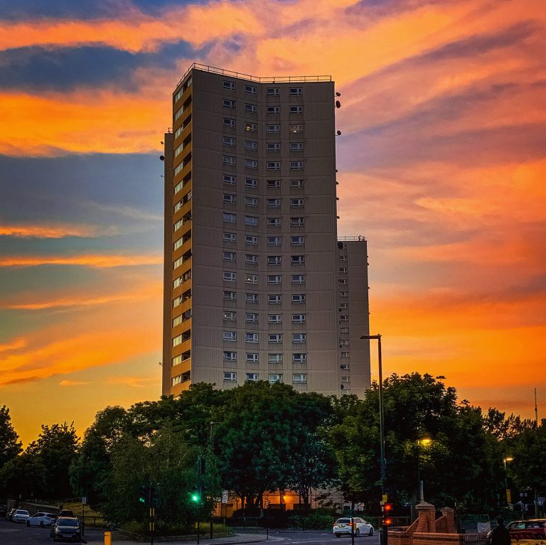 A block of flats in on Horn Lane in Acton set against a majestic sunset sky