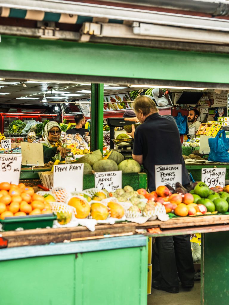 A grocery store in West London lined with colourful, tropical fruit outside