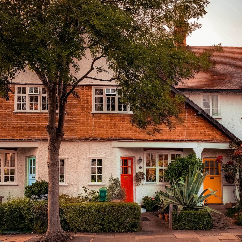 A white West London home with red front door