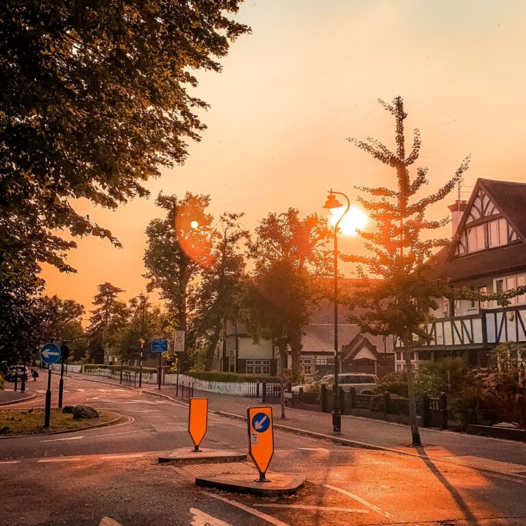 A West London roundabout with a bright, orange sky