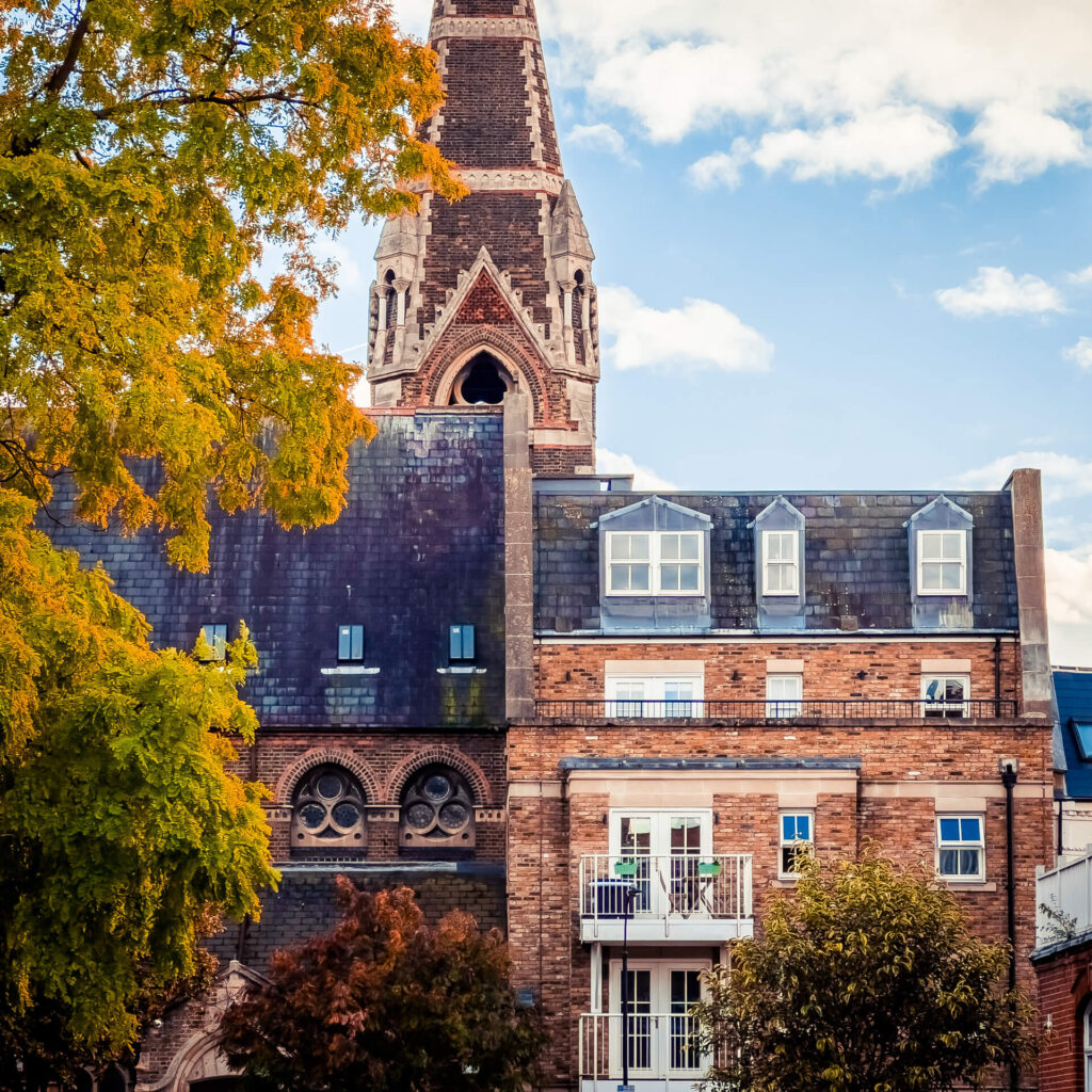 West Kensington house with two balconies with a church spire in the background