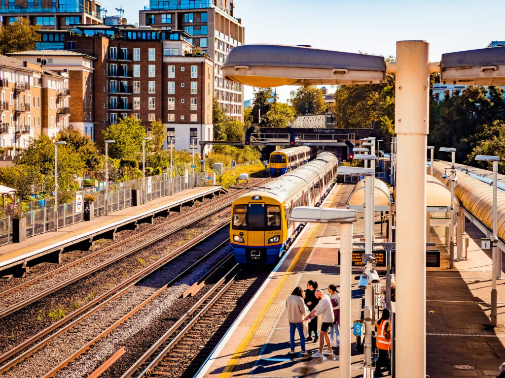 London Overground train pulling in at Kensington Olympia station