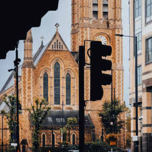 The front of St Paul's Church in Hammersmith set behind a silhouetted traffic light